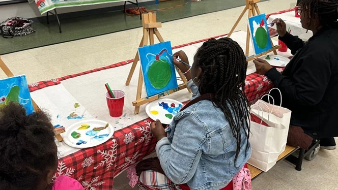 Scholars painting with their families.