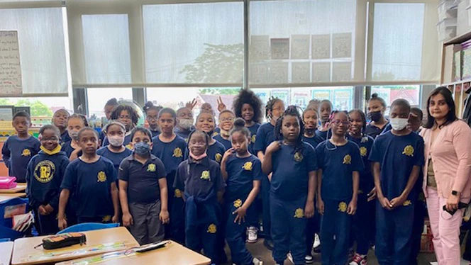 Class standing together for a photo. Class standing together for a photo.