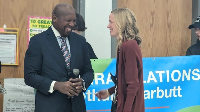 Executive Director of Schools Shawn Leonard congratulates Bethany Garbutt. Executive Director of Schools Shawn Leonard congratulates Bethany Garbutt.
