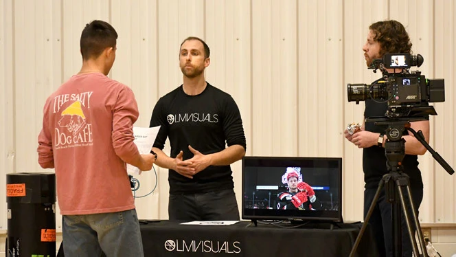 Wellspring Prep student talks to LM Visuals employees.