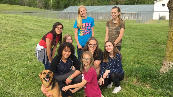 Young women outside with a dog. Young women outside with a dog.