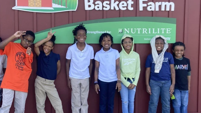 River City students pose outside of Kids Food Basket for photo