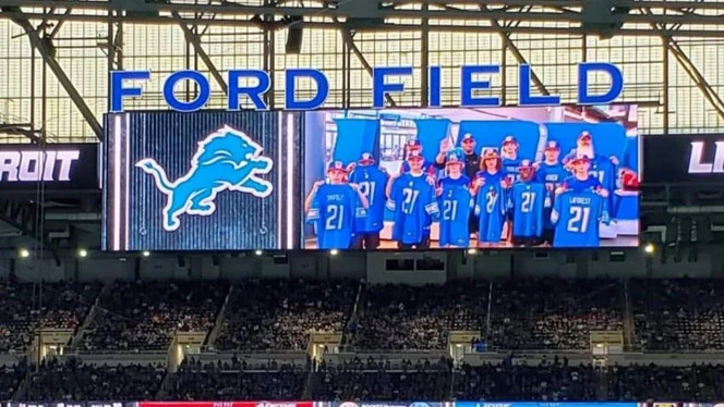 the team on the big screen at Ford Field