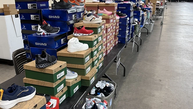 Charter Schools in Grand Rapids: National Heritage Academies partnered with In The Image Shoes Event to provide a pair of shoes to students.