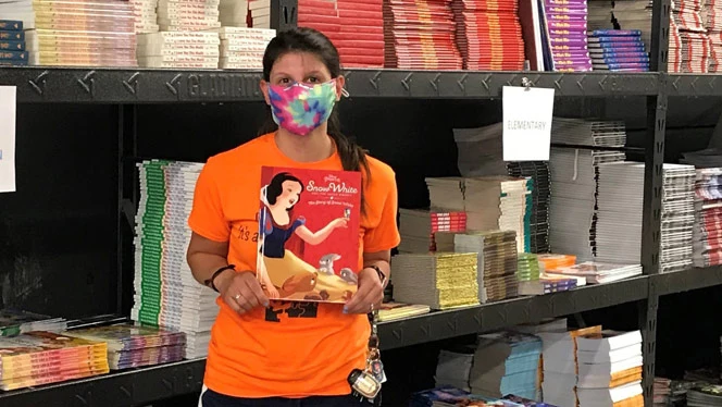 Woman holding up a book