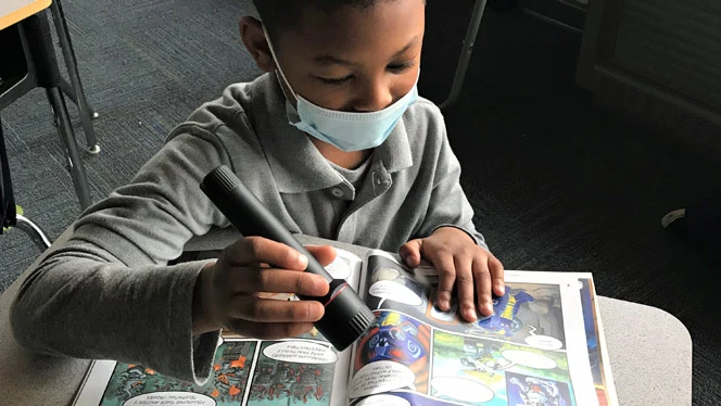 Student reading with a flashlight. Student reading with a flashlight.