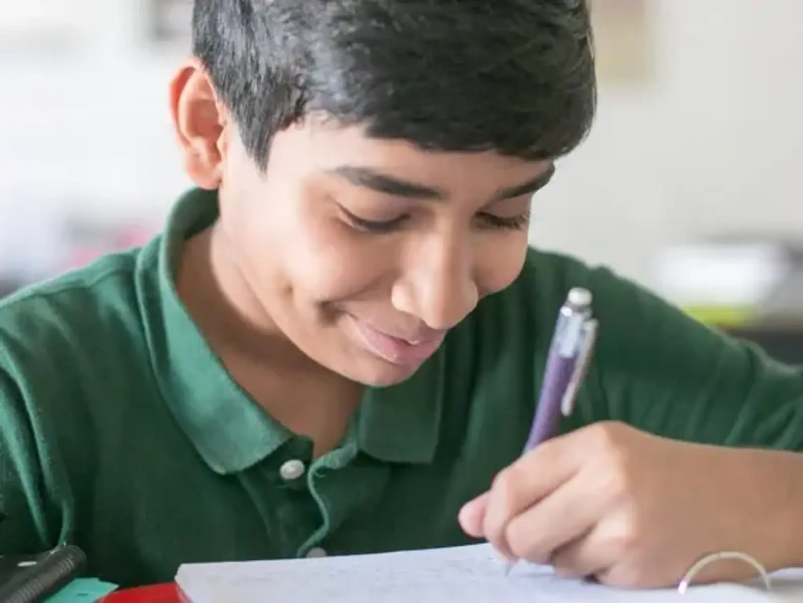 K-8 School in Canton: Student writing in notebook.