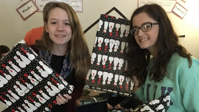 Two children holding wrapped Christmas presents. Two children holding wrapped Christmas presents.