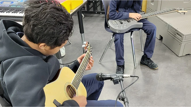 K-8 School in Colorado Springs: Mountain View students playing guitar.
