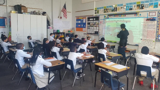 Teacher writing on whiteboard