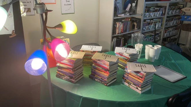 A stack of books assigned to different tables. A stack of books assigned to different tables.