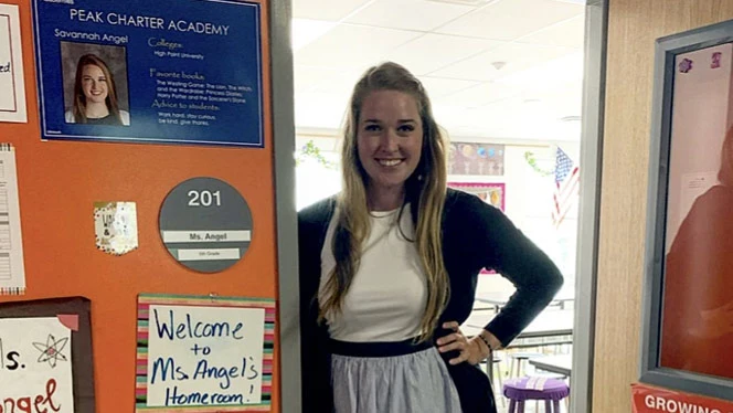 Teacher greeting at the door of her classroom. Teacher greeting at the door of her classroom.