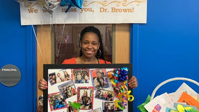 Brown holding a collage