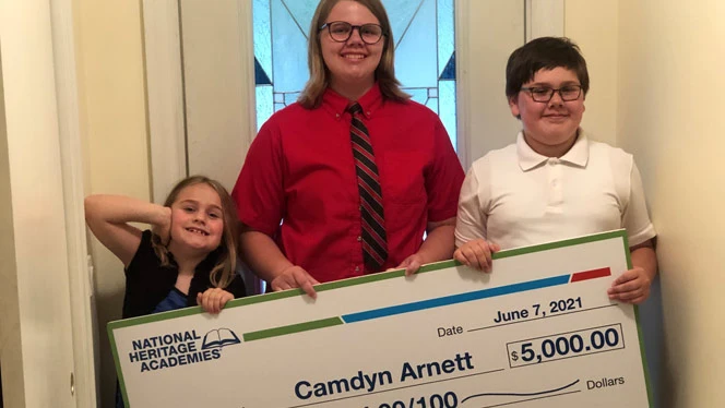students with large check students with large check