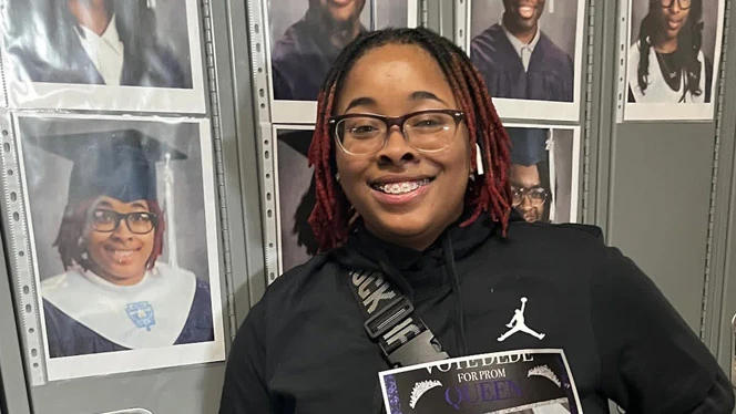 Byrd posing with her graduation photo