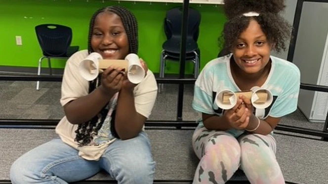 Students showing off their sound amplifiers. Students showing off their sound amplifiers.