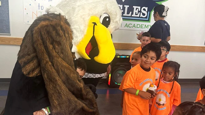 K-9 School in Watkins: Sky Ranch KinderCamp participants hang out with Sky Ranch's mascot, Esme the Eagle.