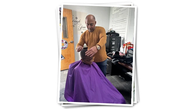Barber giving student a haircut.
