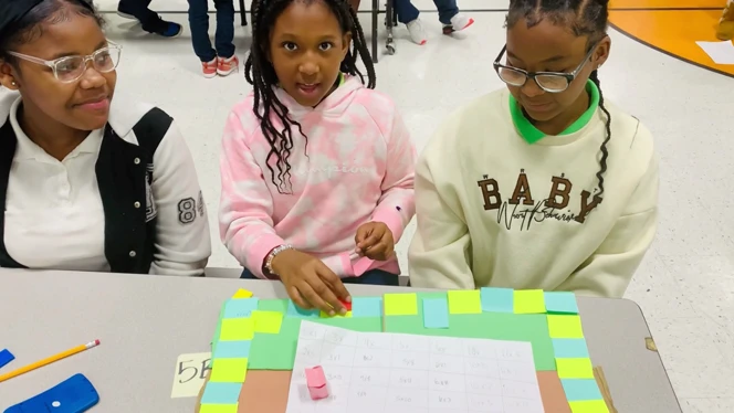 three girls playing board games