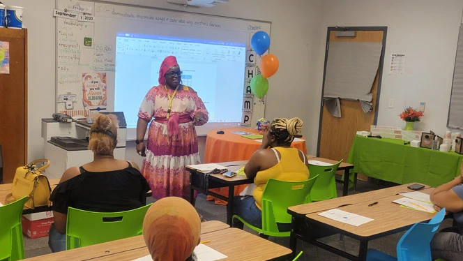 Barrow-Hutson speaking to parents