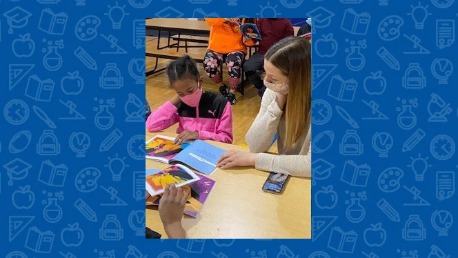 teacher reading with a student