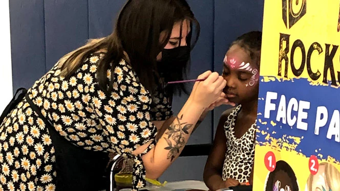 A student getting face paint. A student getting face paint.