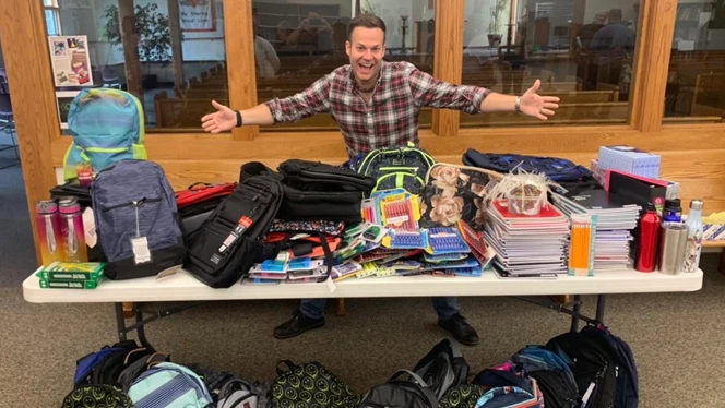 Middle School Dean Josh Barnhart with donated school supplies. Middle School Dean Josh Barnhart with donated school supplies.