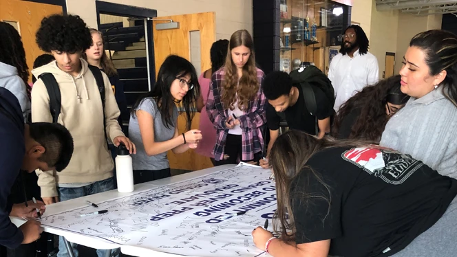 Students signing banner.