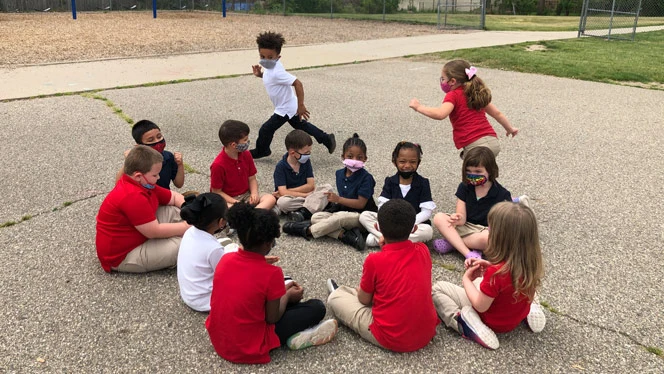 Children playing Duck Duck Goose. Children playing Duck Duck Goose.