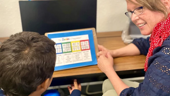 Simone Snyder works with a student
