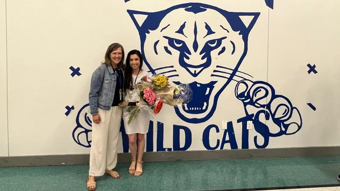 Rachel Licata smiling holding flowers.