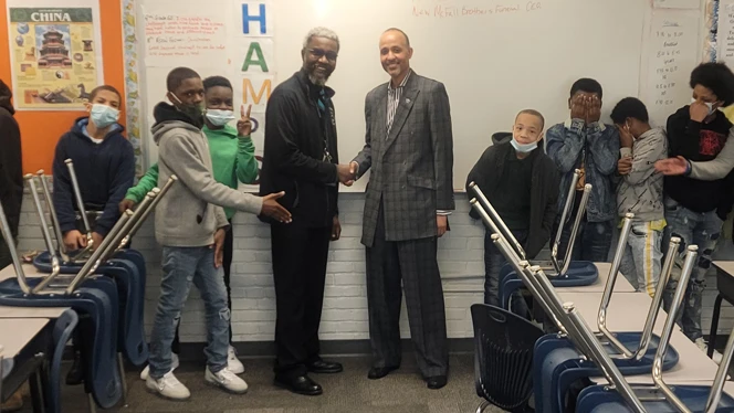 Lemar Tabb shaking hands with those in the school. Lemar Tabb shaking hands with those in the school.