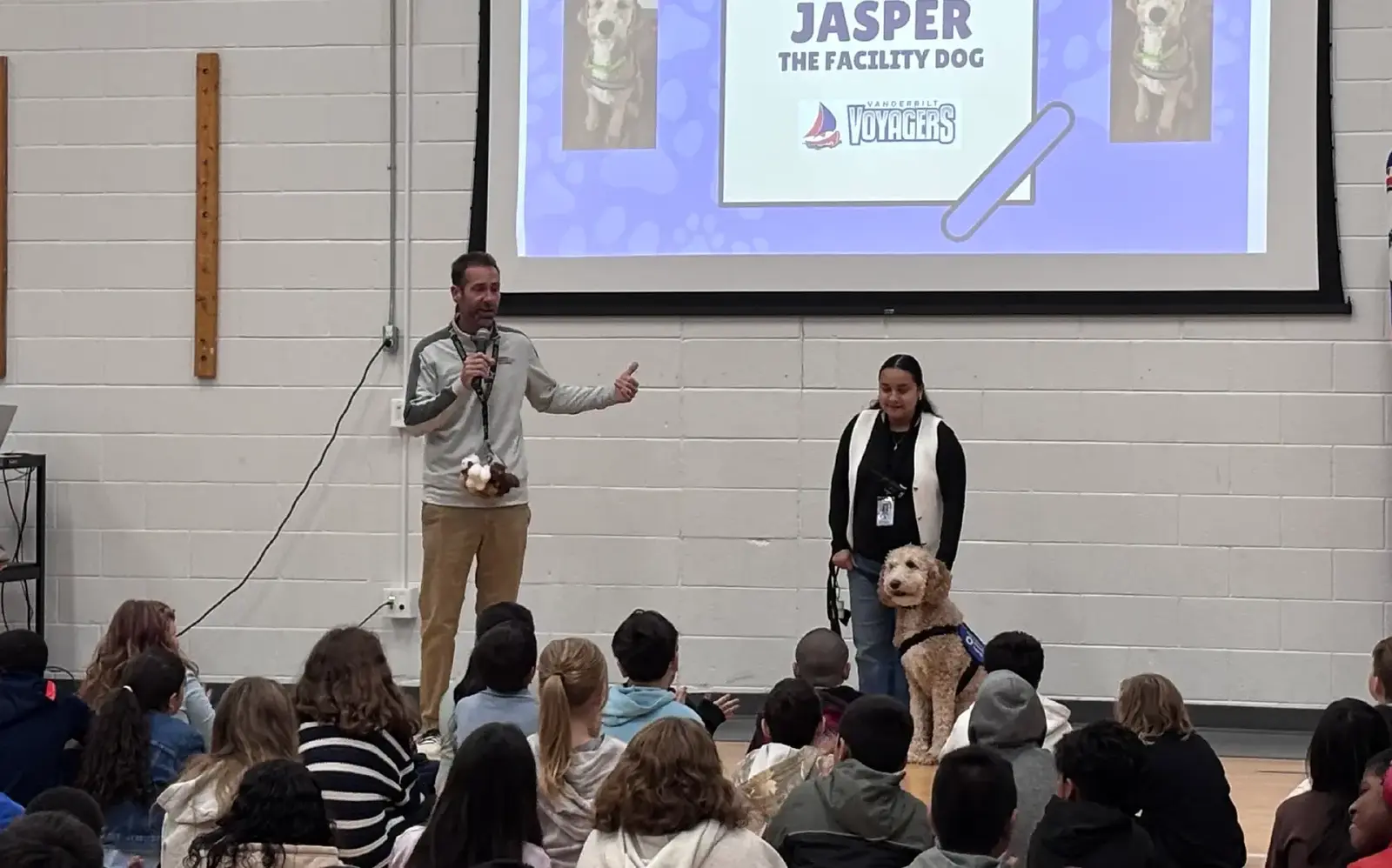 a man and woman standing in front of a group of people