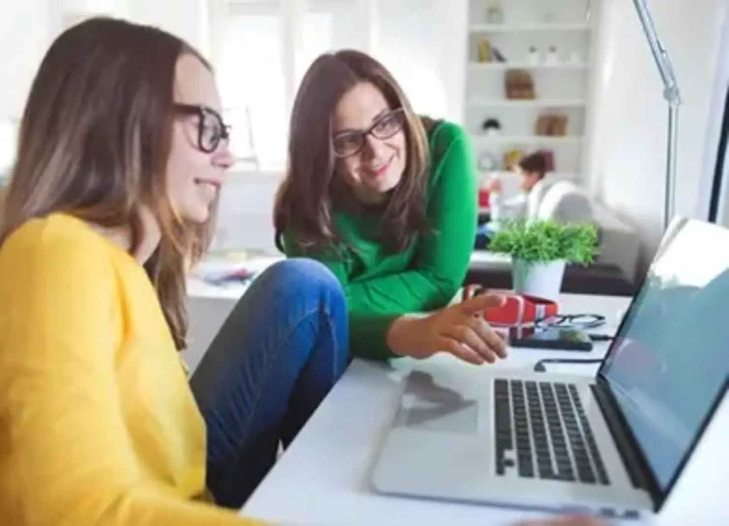 Mom and daughter working at computer