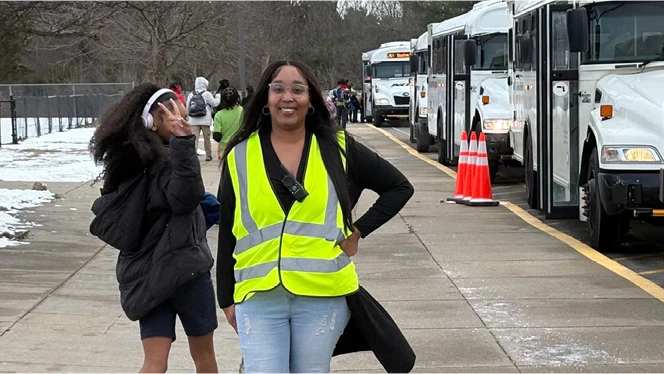 K-8 School in Flint: Linden Charter Academy's liaison poses with buses.