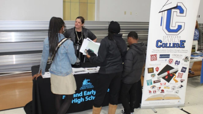 Students asking a representative about their college