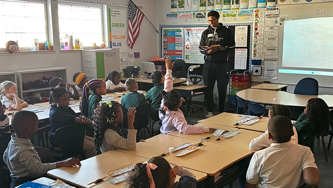 K-8 School in Ypsilanti: EMU football players visited East Arbor students.