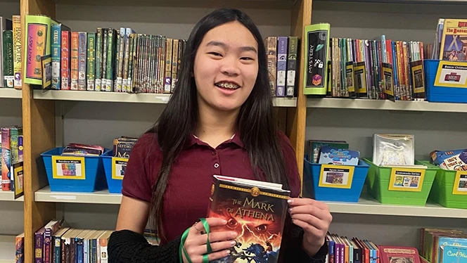 K-8 School in Jackson: Paragon student holding a book.