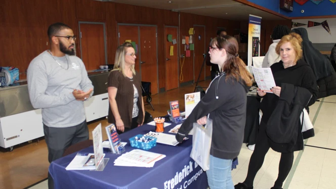 Students asking a representative about their college