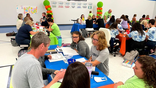 Adults gathered around a table.