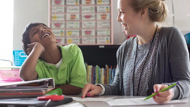 Peak student and teacher laughing