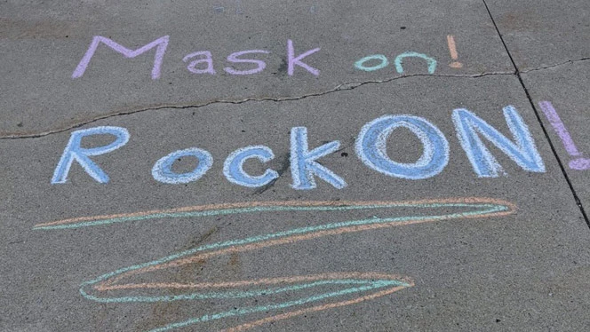 Sidewalk chalk reminding onlookers to wear their masks. Sidewalk chalk reminding onlookers to wear their masks.