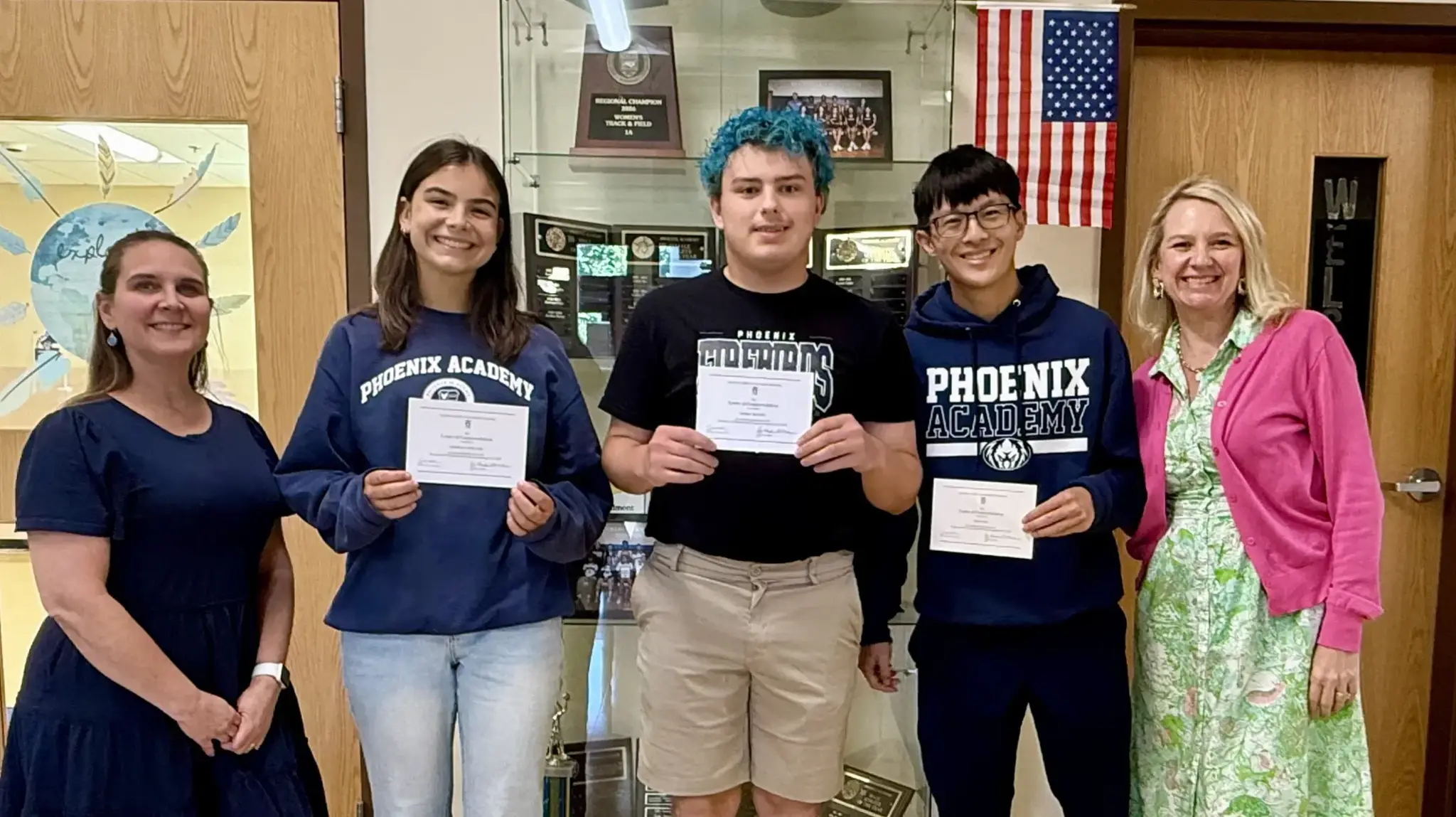 a group of people holding certificates