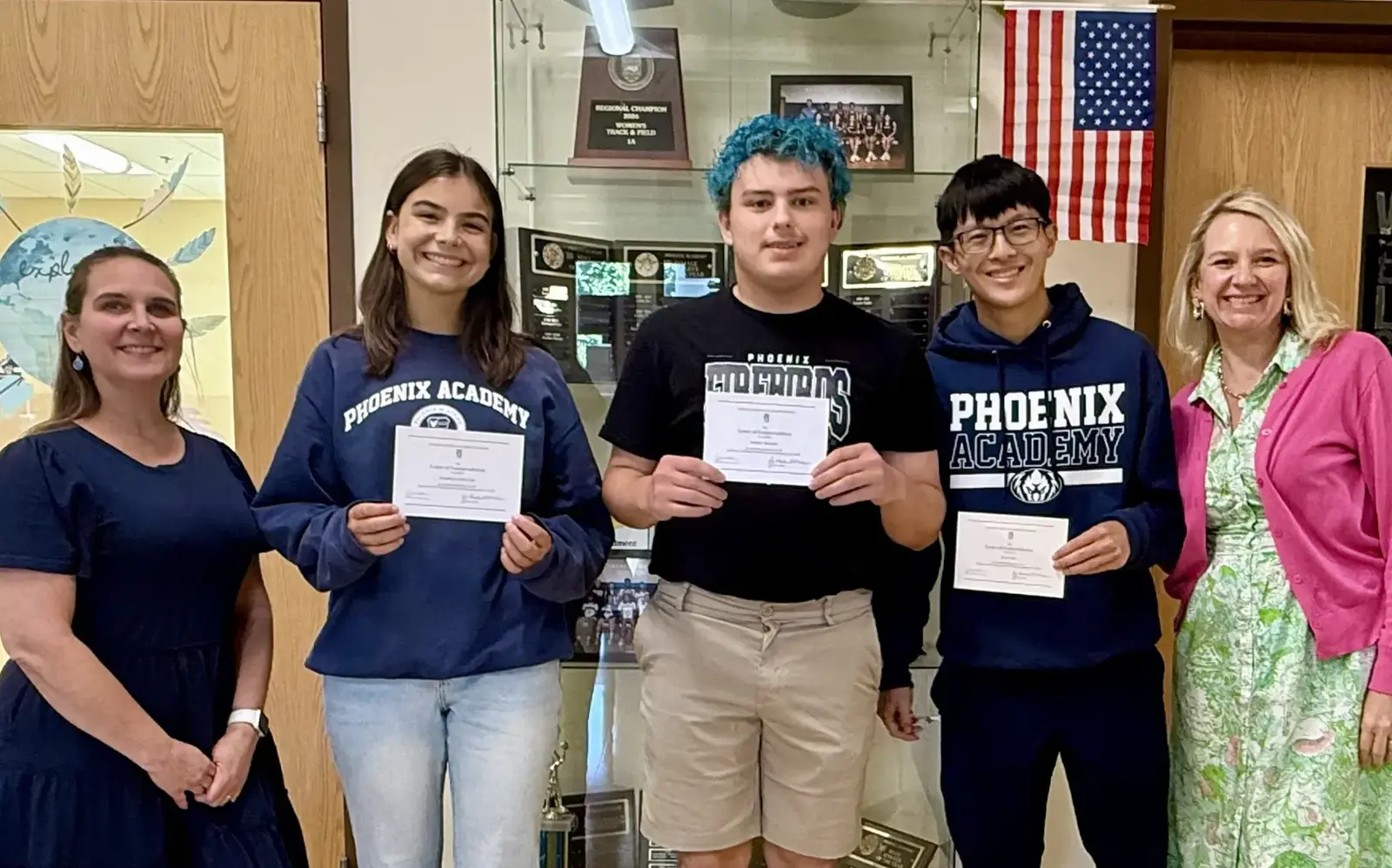 a group of people holding certificates
