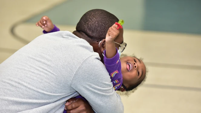 A man hugging a child. A man hugging a child.