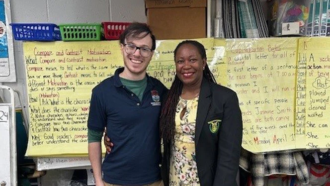 K-8 School in Brooklyn, NY: Racanello posing with school staff in classroom.