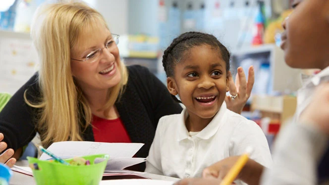 Adult teaching a smiling a child. Adult teaching a smiling a child.