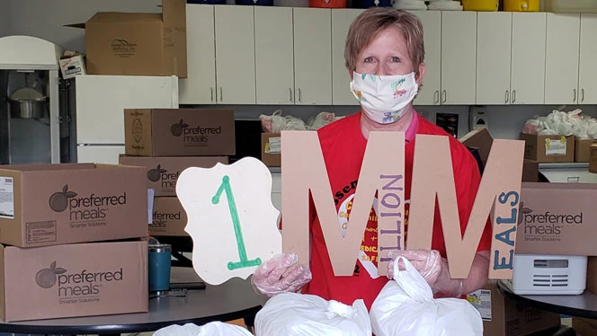Woman holding a sign that says One Million Meals. Woman holding a sign that says One Million Meals.