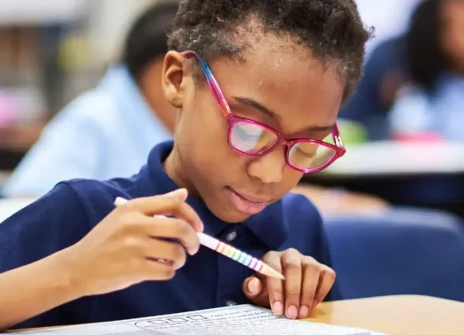 K-8 School in E. Cleveland: Student writing in notebook.