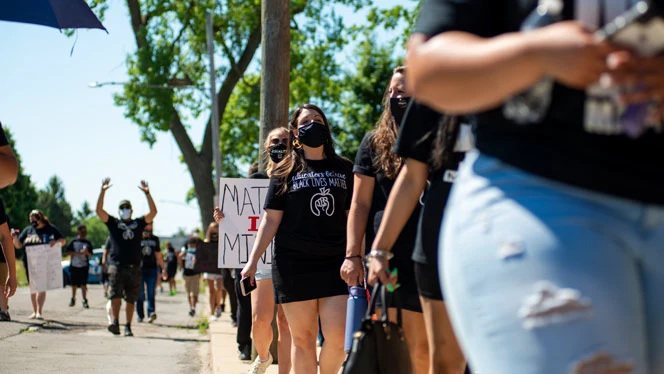Detroit Enterprise staff holding support signs